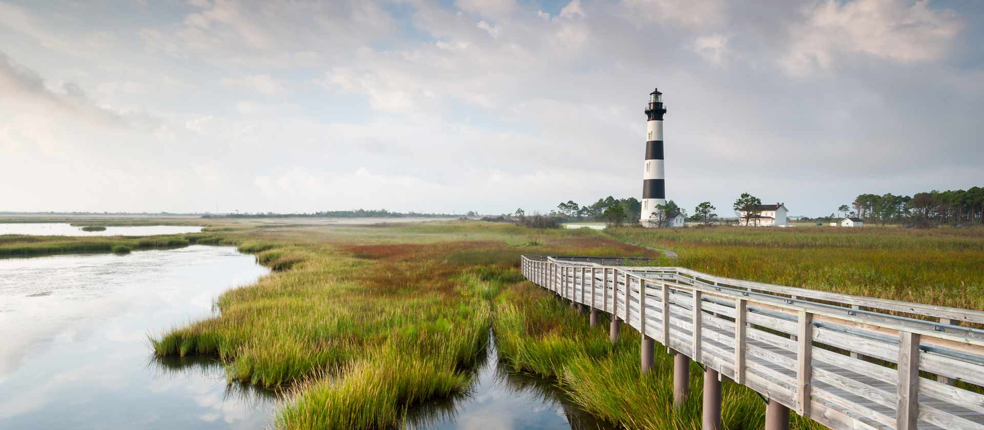 Wooden walkway to lighthouse on a marsh